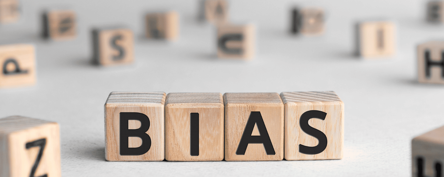 wooden blocks spelling the word bias on a white surface.